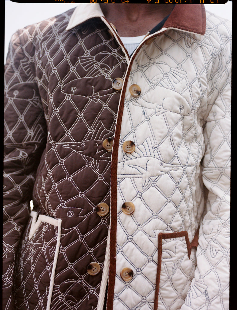 Man showing both sides of reversible jacket 