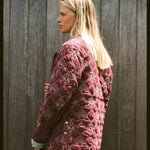 Woman shows the back of her jacket 