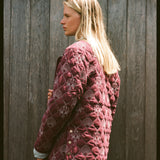 Woman shows the back of her jacket 