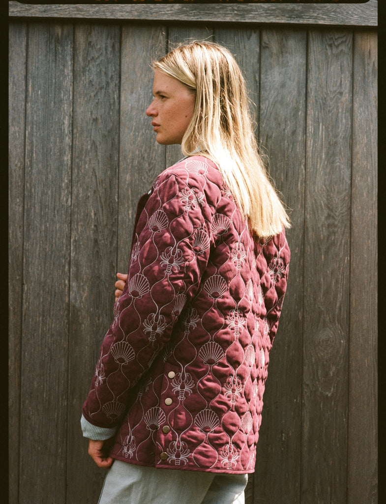 Woman shows the back of her jacket 
