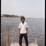 Man stands at end of dock