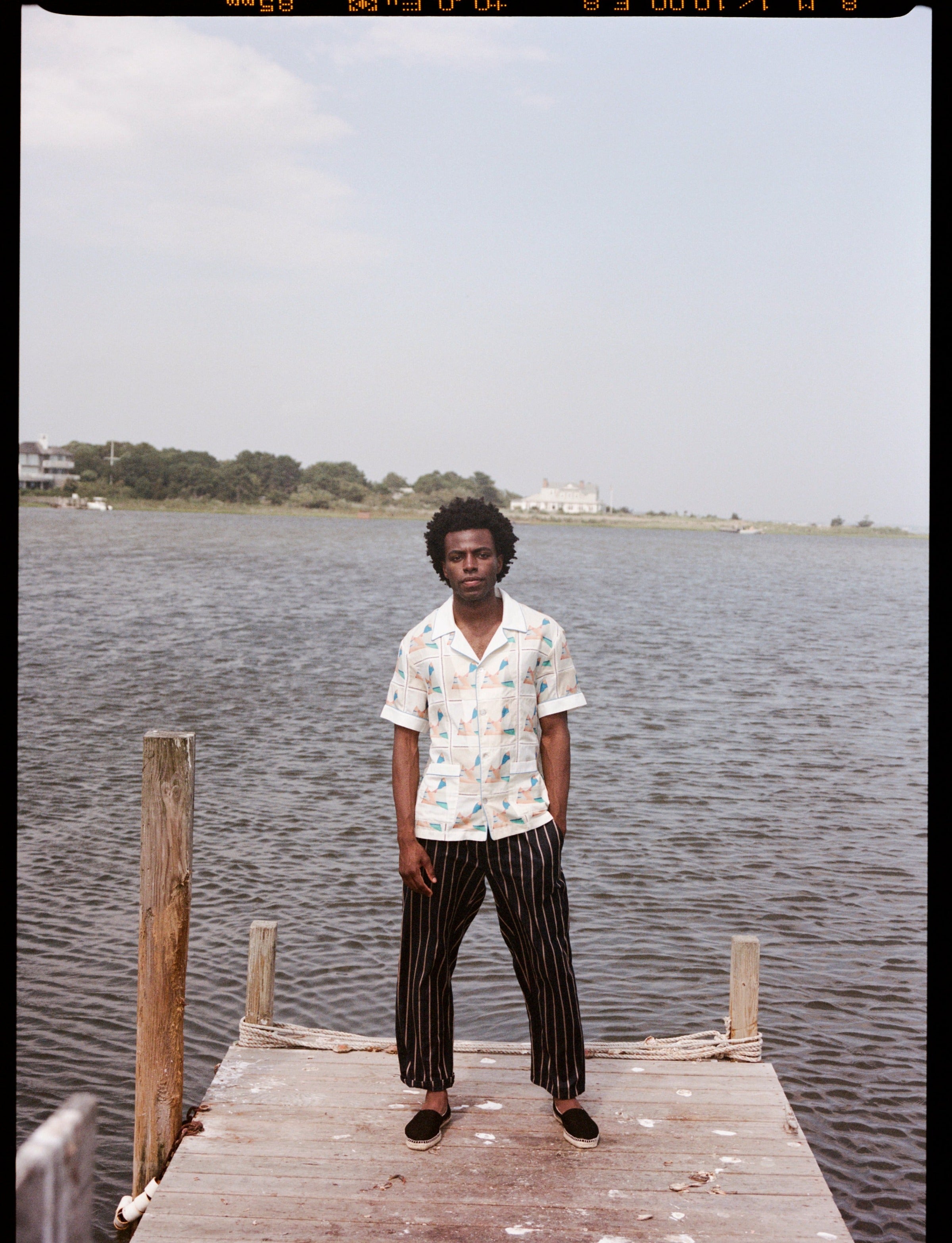 Man stands at end of dock