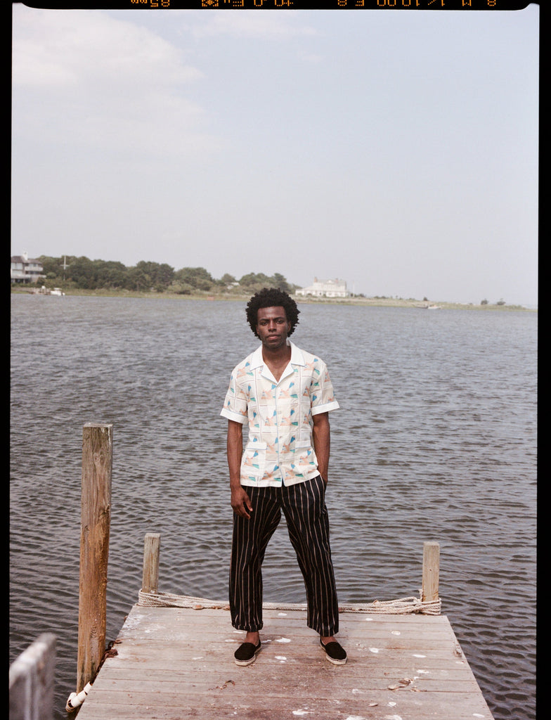 Man stands at end of dock