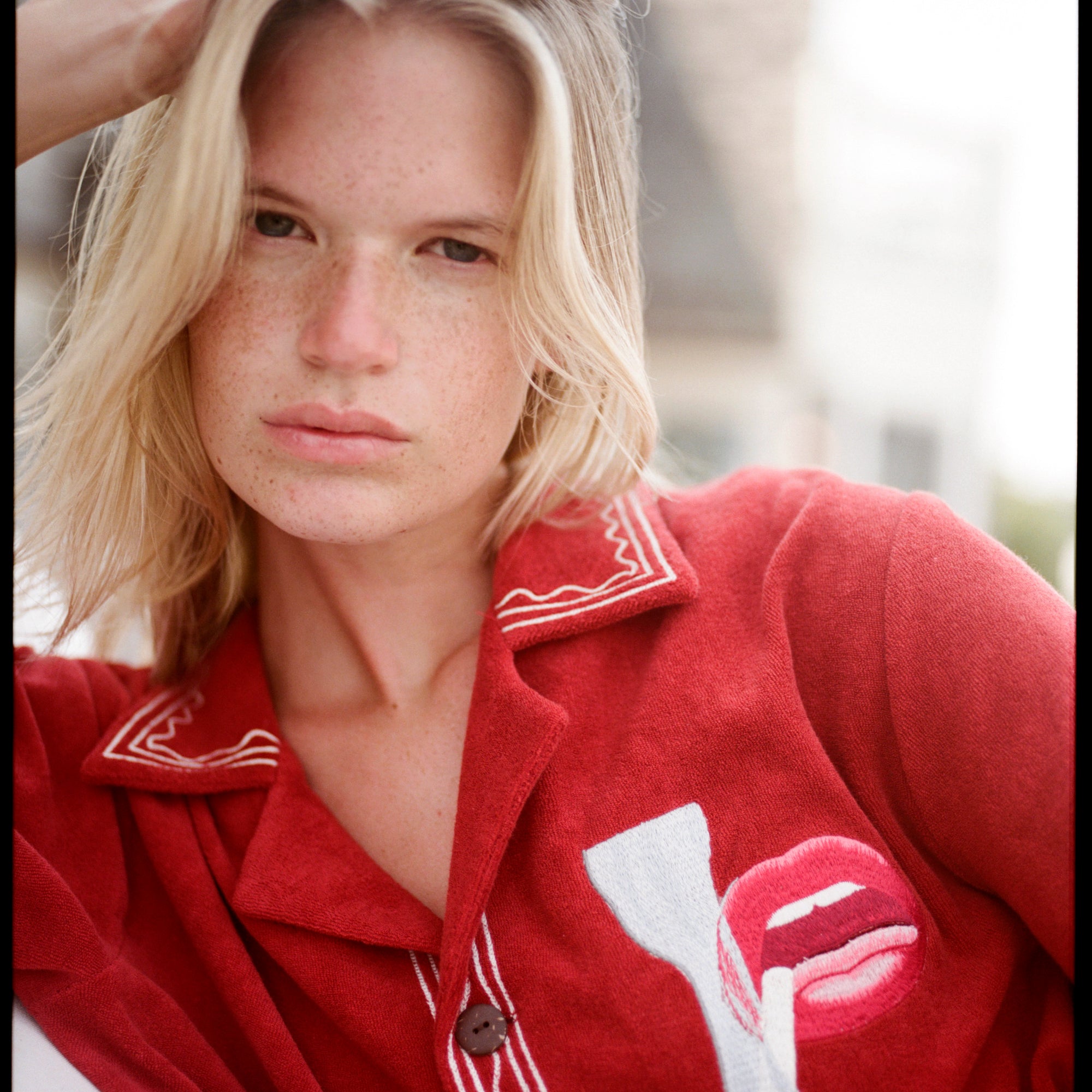 Close up of woman staring at the camera with hand in hair