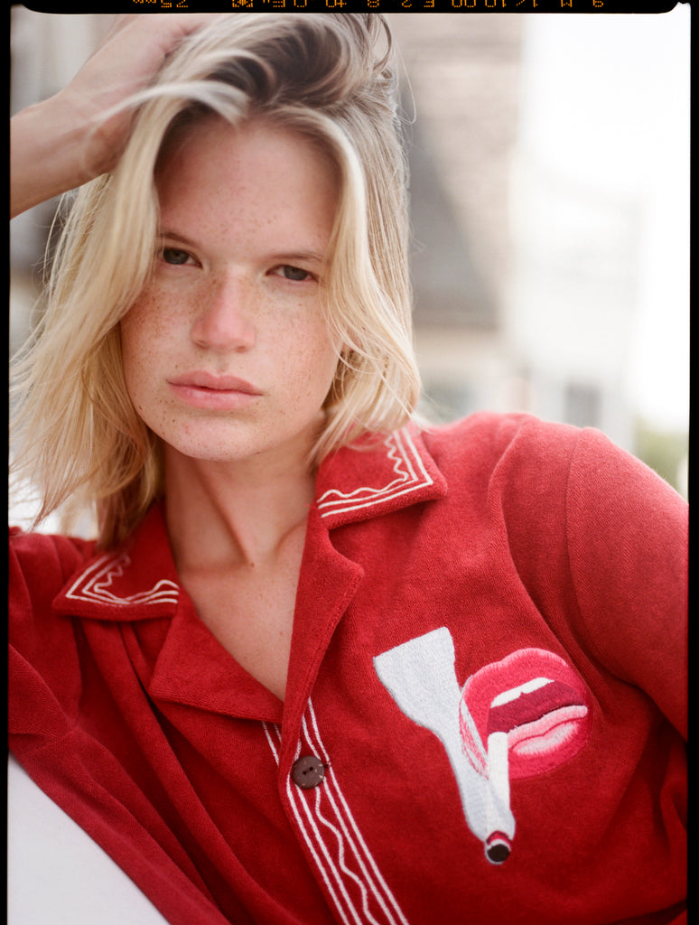 Close up of woman staring at the camera with hand in hair