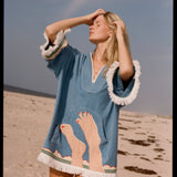 woman closes eyes with hands in her hair