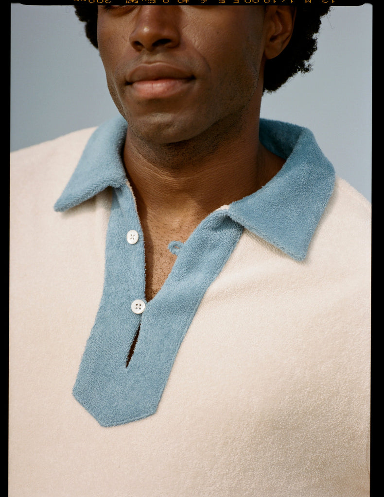 CLose up of buttons on collar showing bottom half of mans face