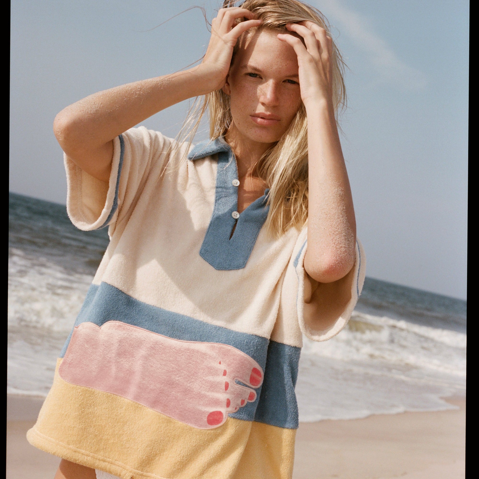 Woman puts both hands through her hair 