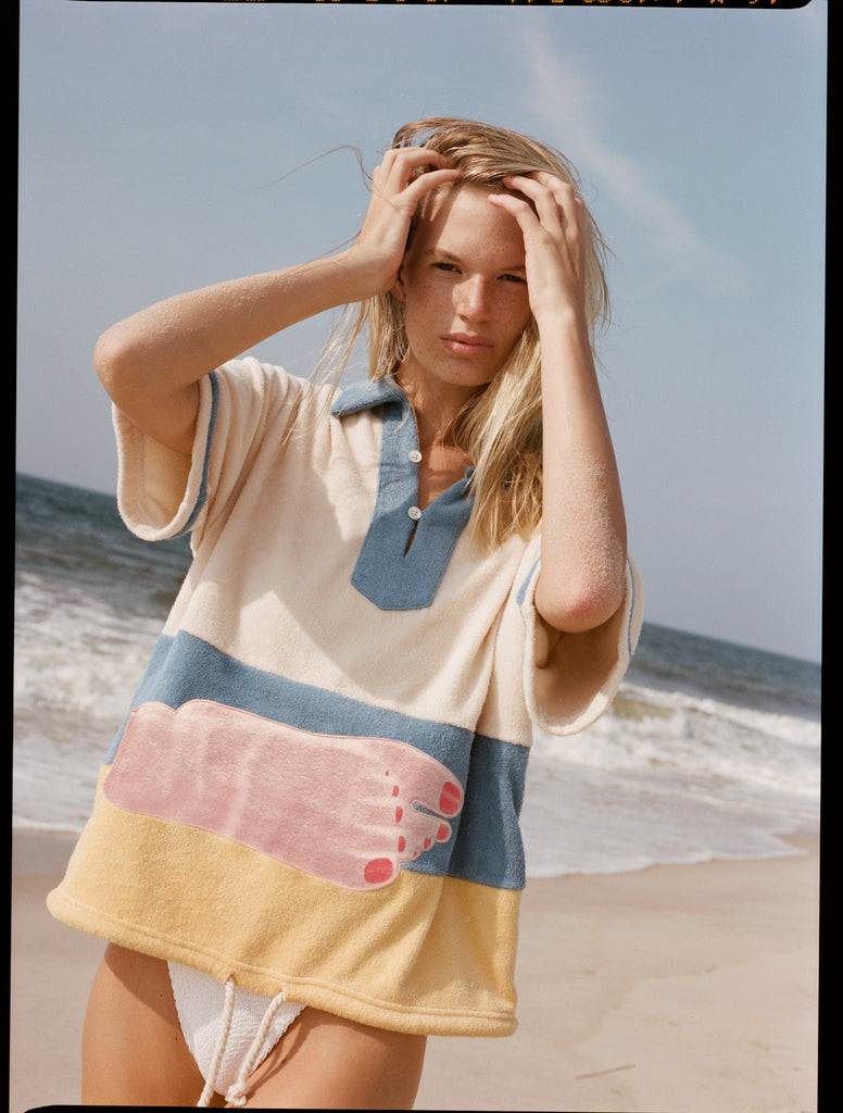 Woman puts both hands through her hair 