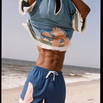 man takes off poncho over his head