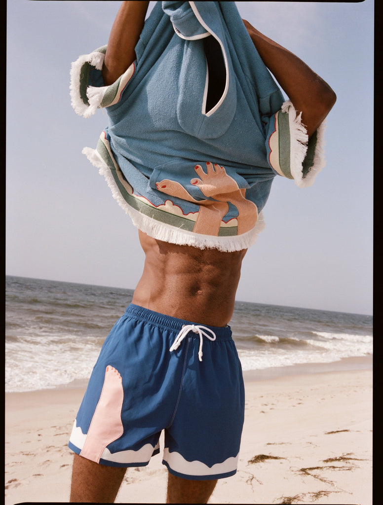 man takes off poncho over his head
