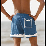 Shot of the backside of a model at the beach wearing the swim trunks