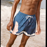 Photo of model wearing swim trunks after a dip in the ocean