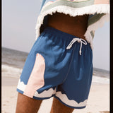 Seascape #2 swim trunks being worn by a model on the beach