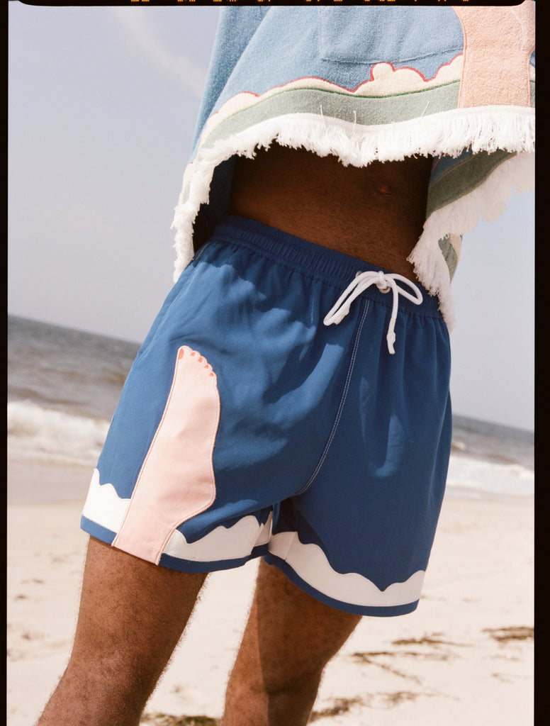 Seascape #2 swim trunks being worn by a model on the beach