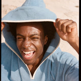 man smiles and looks up at camera