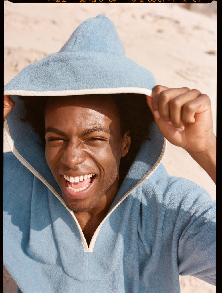 man smiles and looks up at camera