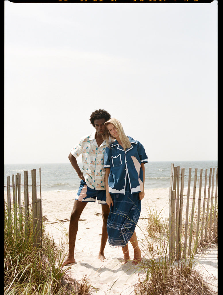 Full body shot of man and woman posing together on the beach