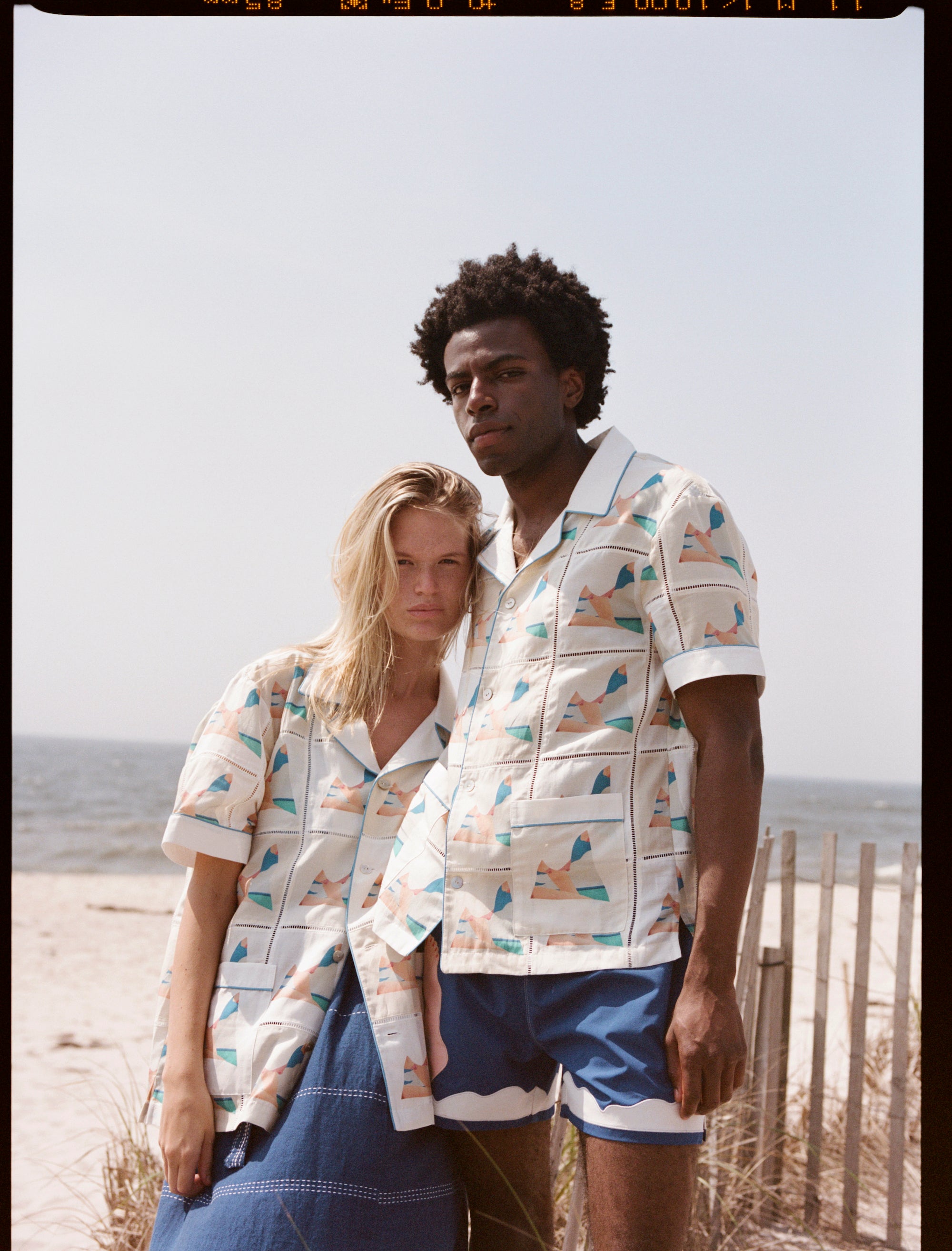 Man and woman pose together looking at the camera