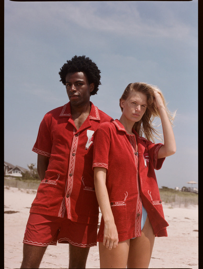 Man in woman pose on the beach wearing matching sets