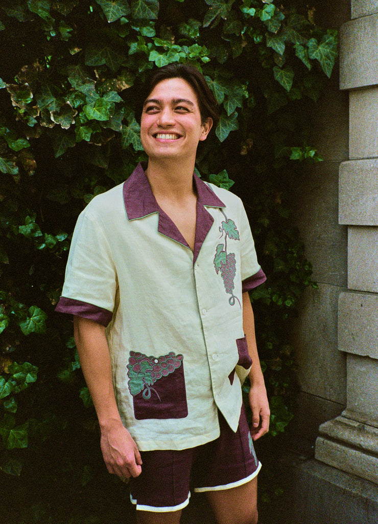 Lukas wearing the full tombarolo set smiling and looking up