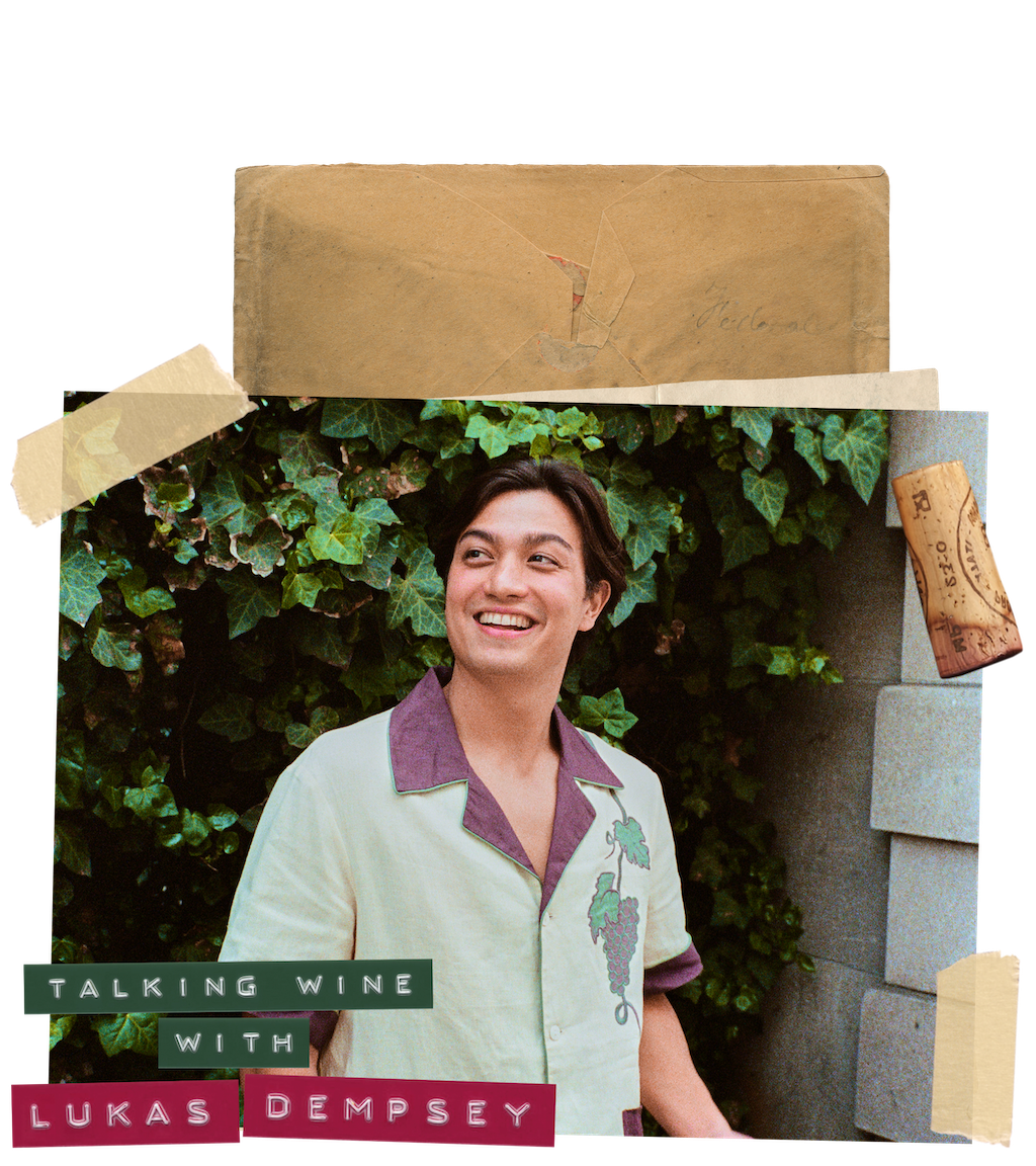 Man smiles mid-speech in front of an ivy wall wearing a wine-themed linen Tombolo shirt 