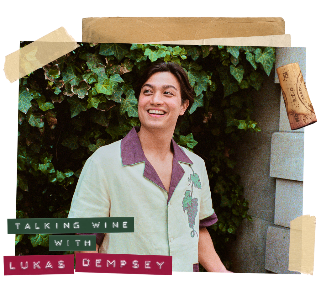 Man smiles mid-speech in front of an ivy wall wearing a wine-themed linen Tombolo shirt 