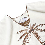 A detailed shot of the shirt's interior label, which features a half coconut with "Tombolo" written across. 