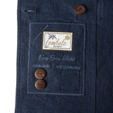 Close up image of the Tombolo tag on the inside of the jacket that features two spare buttons.