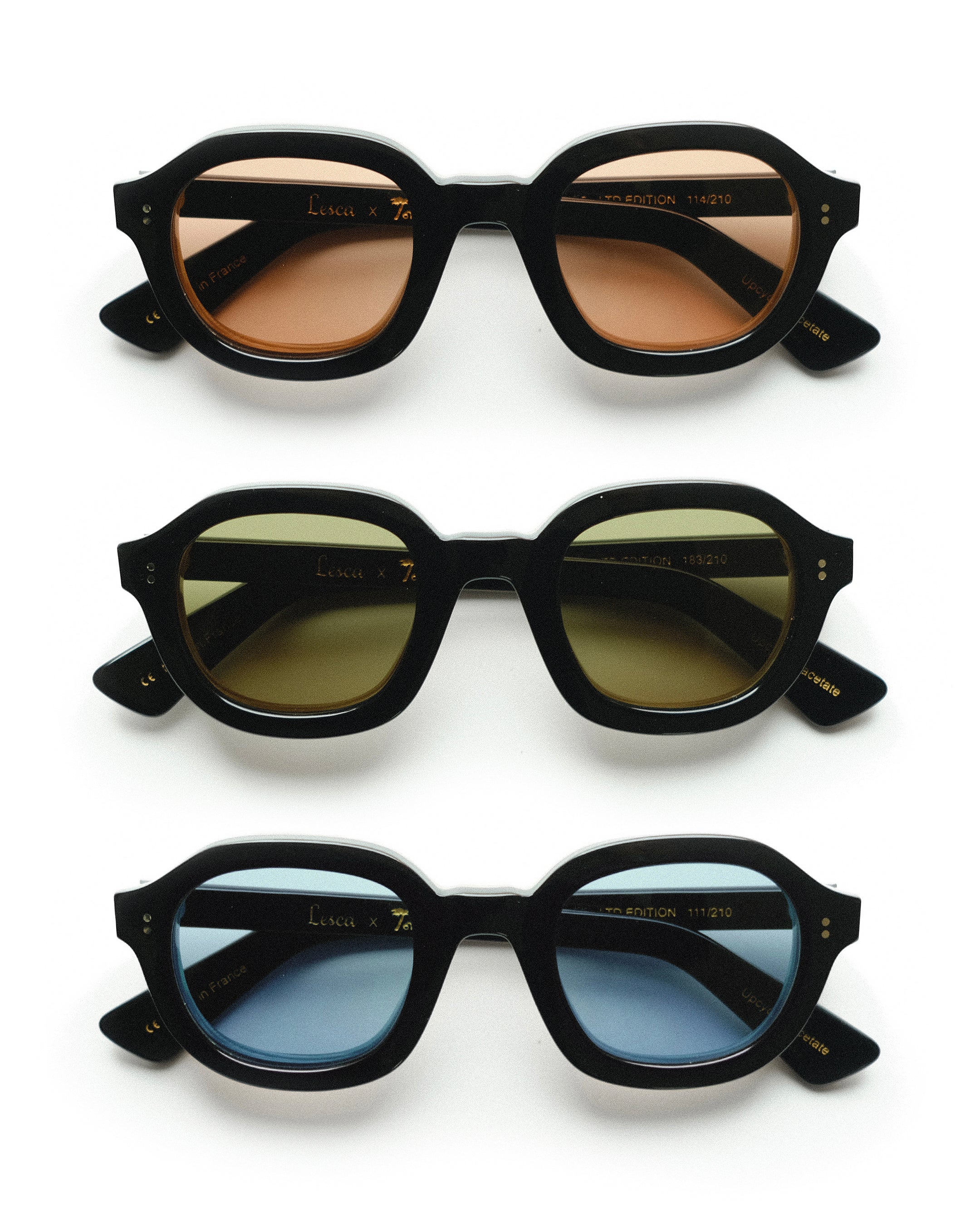 Three variations of the Lesca Lunetier X Tombolo Lenses where all feature a black lens frame and different lens colors (Charcoal, Azure, and Coral) with front-facing product imagery where the glasses appear above one another on a white background.
