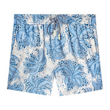 Front-facing product image of 'Palm Fronds Swim Trunks (Blue)' that showcase a repeating vintage Palm Frond pattern throughout, metal eyelet stoppers on blue and white twist drawstrings, and a zippered side pocket concealed on right side seam, all shot on a white background.