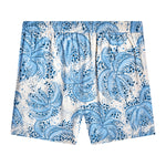 Backwards-facing product image of "Palm Fronds Swim Trunks (Blue)" that features a repeating vintage Palm Frond print and signature 'V' back pocket.