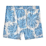 Backwards-facing product image of "Palm Fronds Swim Trunks (Blue)" that features a repeating vintage Palm Frond print and signature 'V' back pocket.