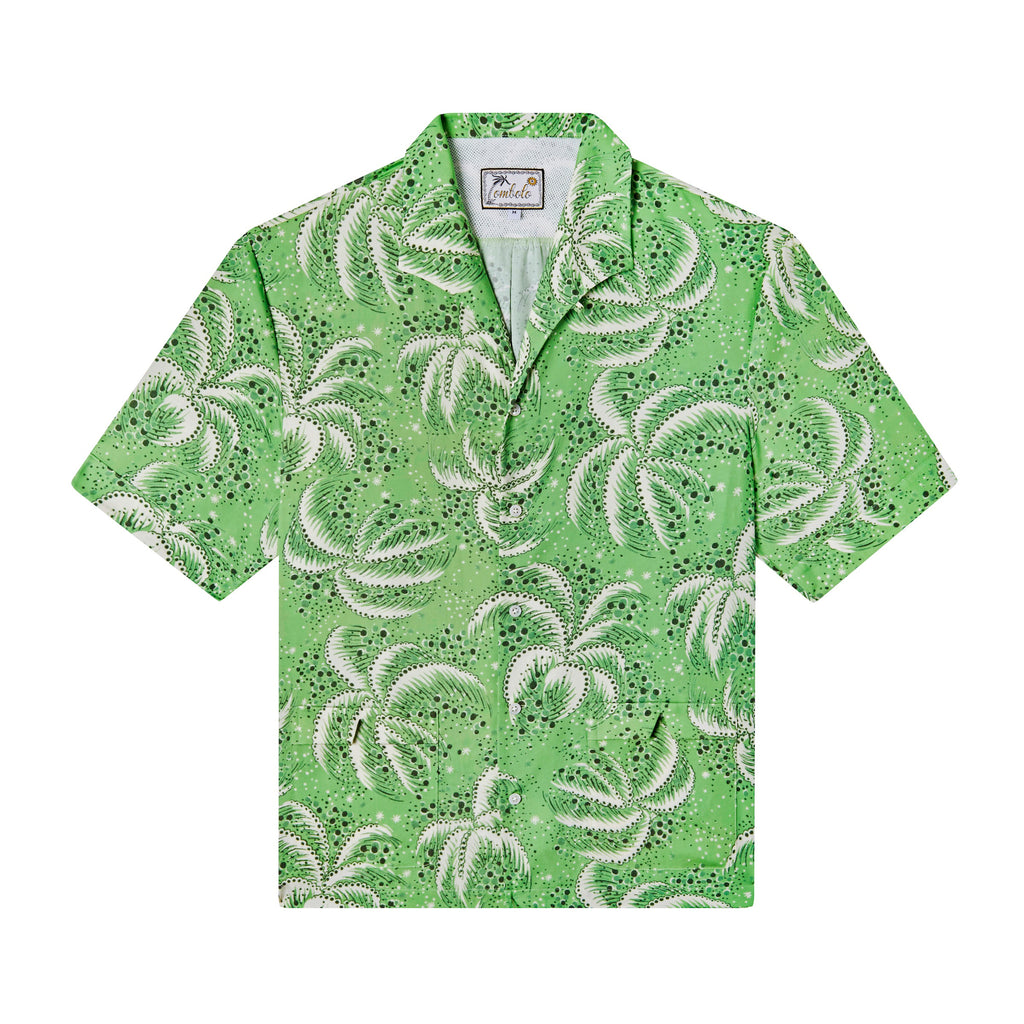Front-facing product image of 'Palm Fronds (Green)' made of 100% Tencel that showcases its repeated Palm Frond patter, a unique, curved camp collar with no notch that lays flat, and V-slits on cuffs and lower patch pockets, all shot on a white background.