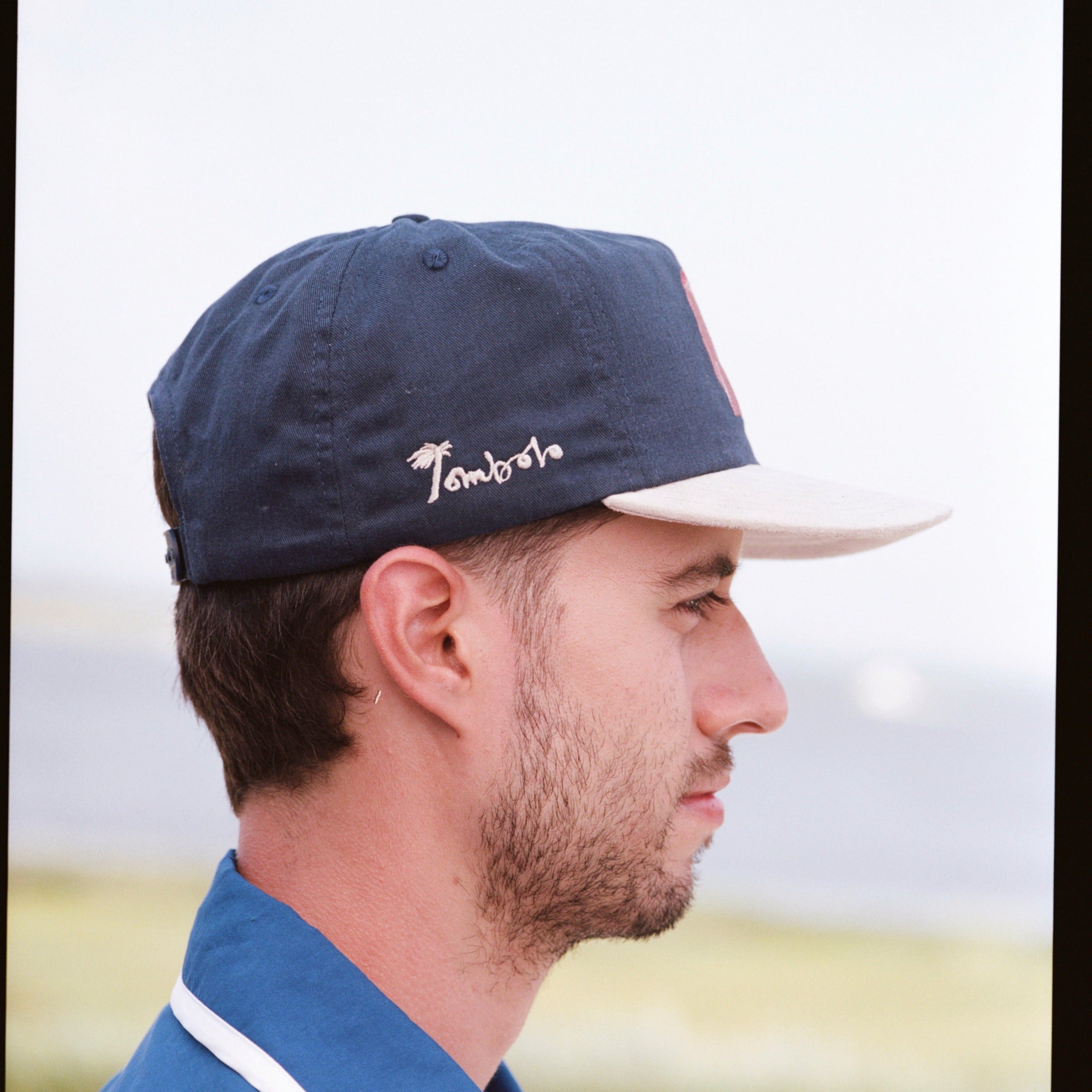 Man shows other side of navy cap