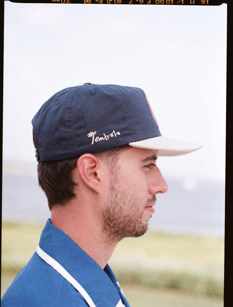 Man shows other side of navy cap