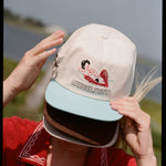 woman wears three caps covering her face