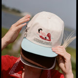 woman wears three caps covering her face
