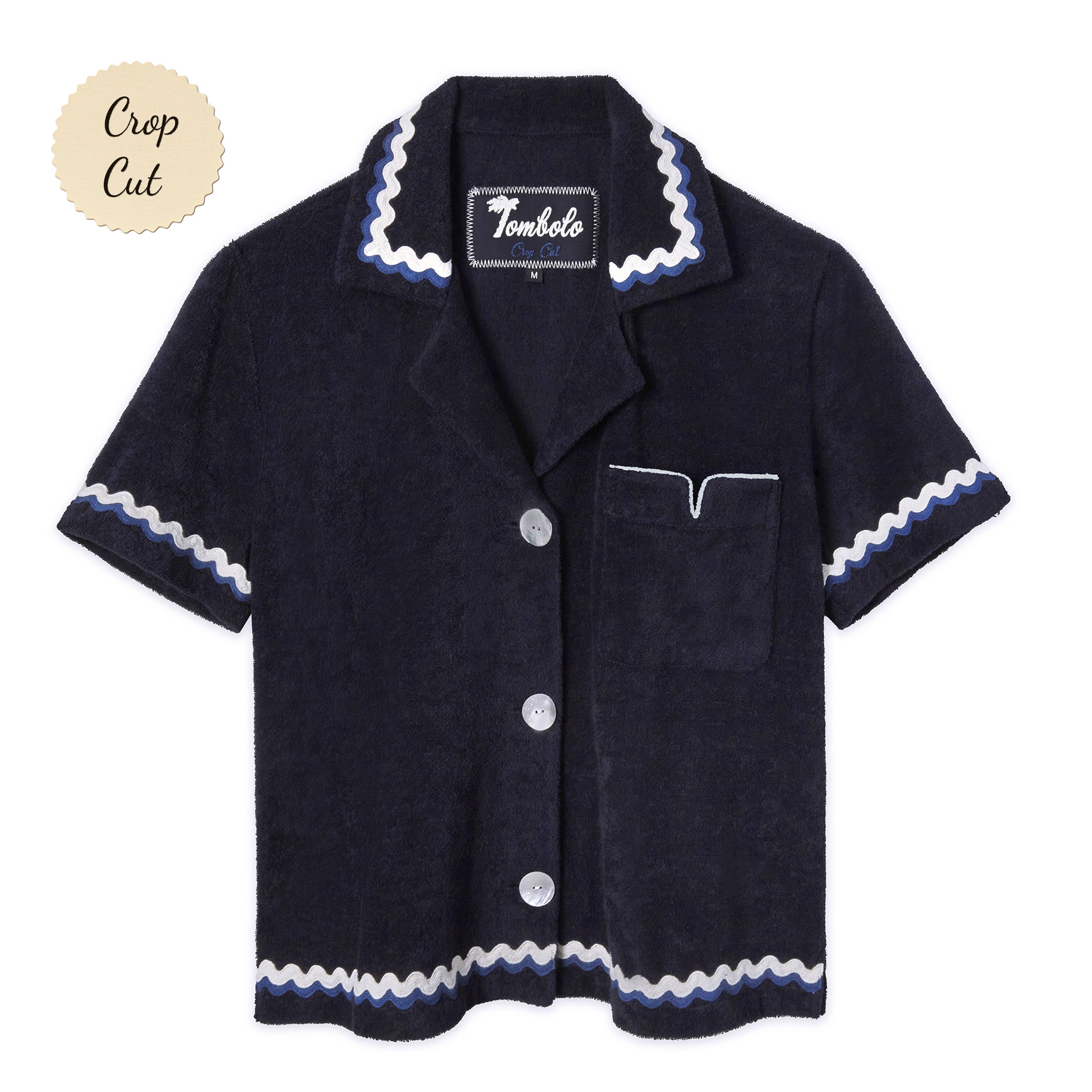 Front-facing product image of the 'Rick Rack' Cabana ~ Crop Cut (Midnight Blue) made of Organic Cotton Terry Cloth and featuring and featuring oversized agoya shell buttons, signature Tombolo v-slit pocket on chest, overlapping rick rack embroidery on collar, cuffs, and bottom sweep, and a custom woven Tombolo label.