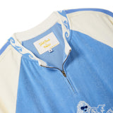 Close-up of a light blue and cream quarter-zip cabana shirt