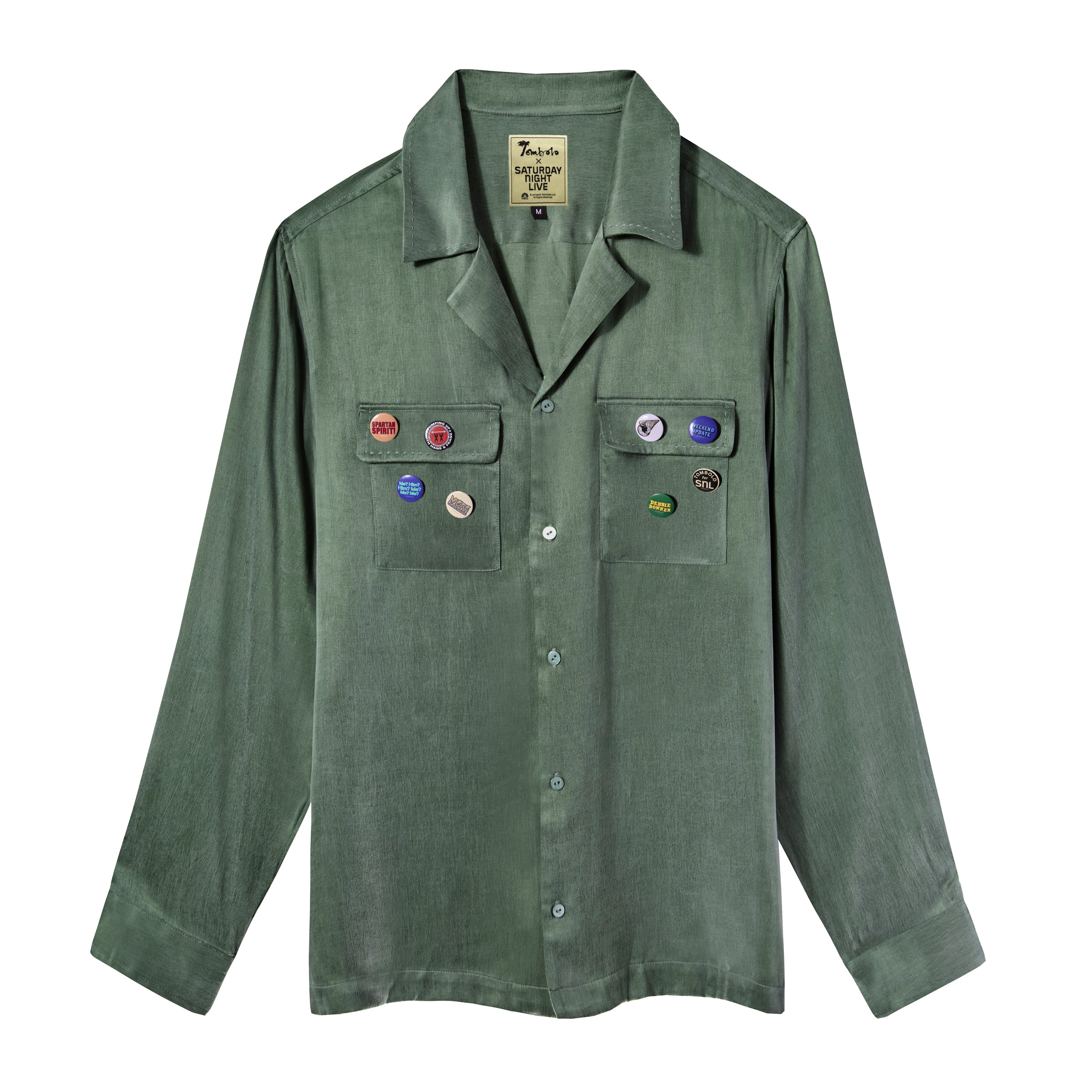 Olive green long-sleeve button-up shirt with two chest pockets and assorted SNL pin badges.