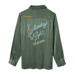 Green shirt with 'Saturday Night Live' text embroidered across the back.