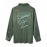 Green shirt with 'Saturday Night Live' text embroidered across the back.