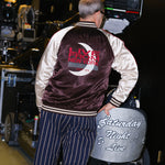 Tom Broecker standing with his back to the camera, showing off the back of the SNL Souvenir Jacket. 