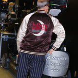 Tom Broecker standing with his back to the camera, showing off the back of the SNL Souvenir Jacket. 