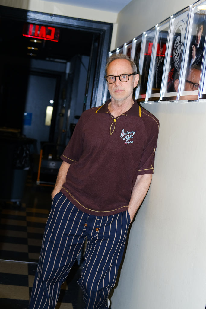 SNL Costume Designer, Tom Broecker, seen wearing the SNL 'Tompolo' with Easy Going Striped Navy pants, and his hands in pocket. 