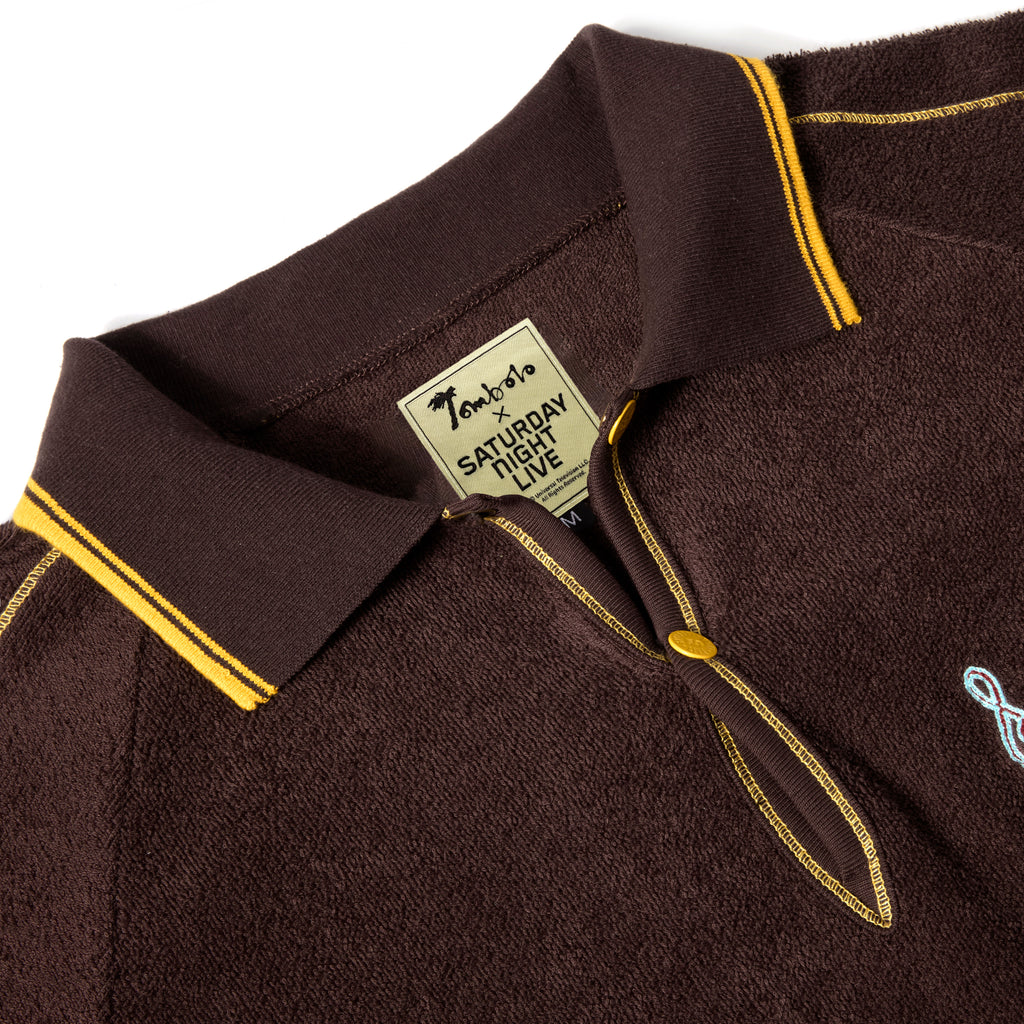 Close-up of the top of the SNL Tompolo, featuring an interior label with 'Tombolo x Saturday Night Live' stitched.