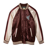 A satin souvenir jacket with 'Saturday Night Live' text and design elements, featuring a mix of maroon, beige, and white colors with red piping.