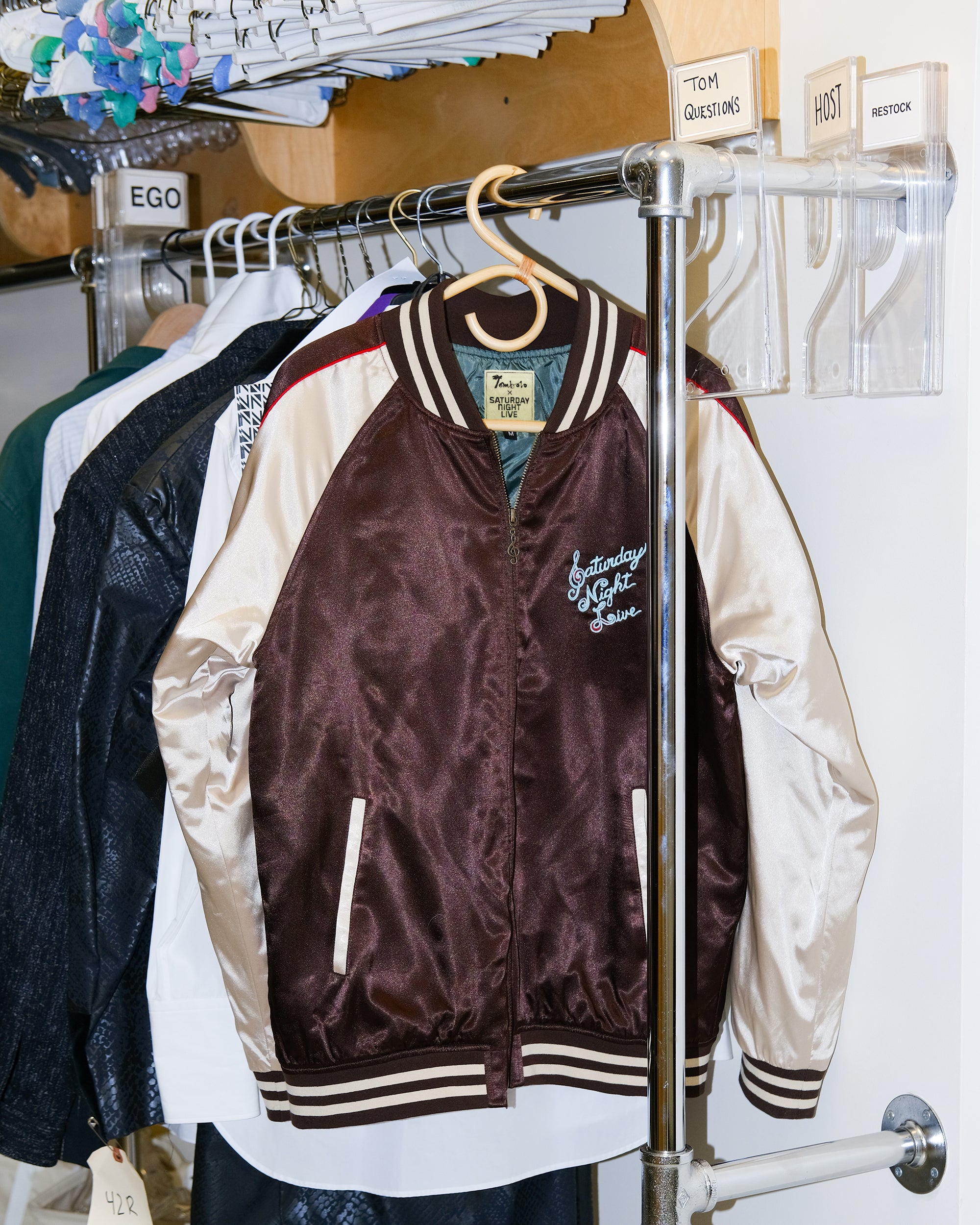 SNL satin Souvenir Jacket is seen hanging in an SNL dressing room. 