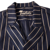 Close-up product image of the Tombolo stitched logo on the inside of the easy-going jacket in navy jacquard stripe, shot on a white background.